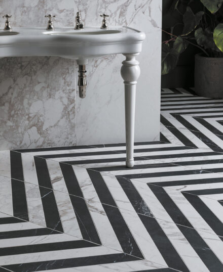 Bathroom featuring Piazzo Bianco Matt Porcelain Chevron tiles and white sink unit and white marble effect wall