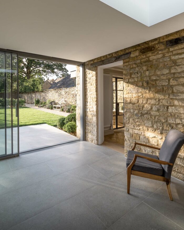 Home with open patio doors to patio area tiled with Kast Light Grey Porcelain indoor and outdoor tiles