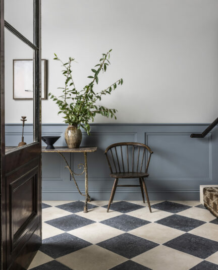Large tumbled limestone floor tiles in a chequerboard design.