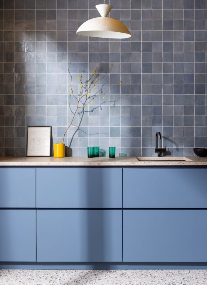 Blue zellige style tile as a backsplash in a blue kitchen.