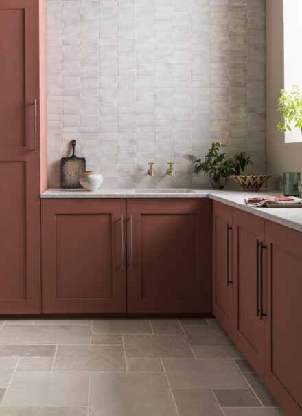 White Zellige tiles in a kitchen with muted pink cabinets and Trulli Sand Matt Stone Effect Porcelain floor tiles.