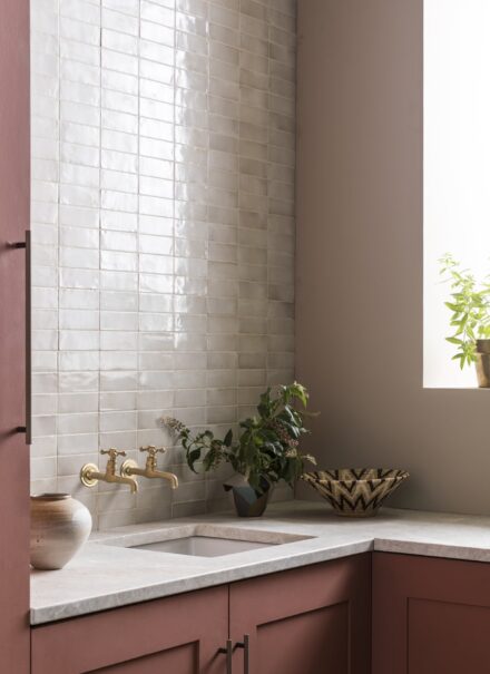 White Zellige tiles featured on a kitchen wall, reflecting the light.