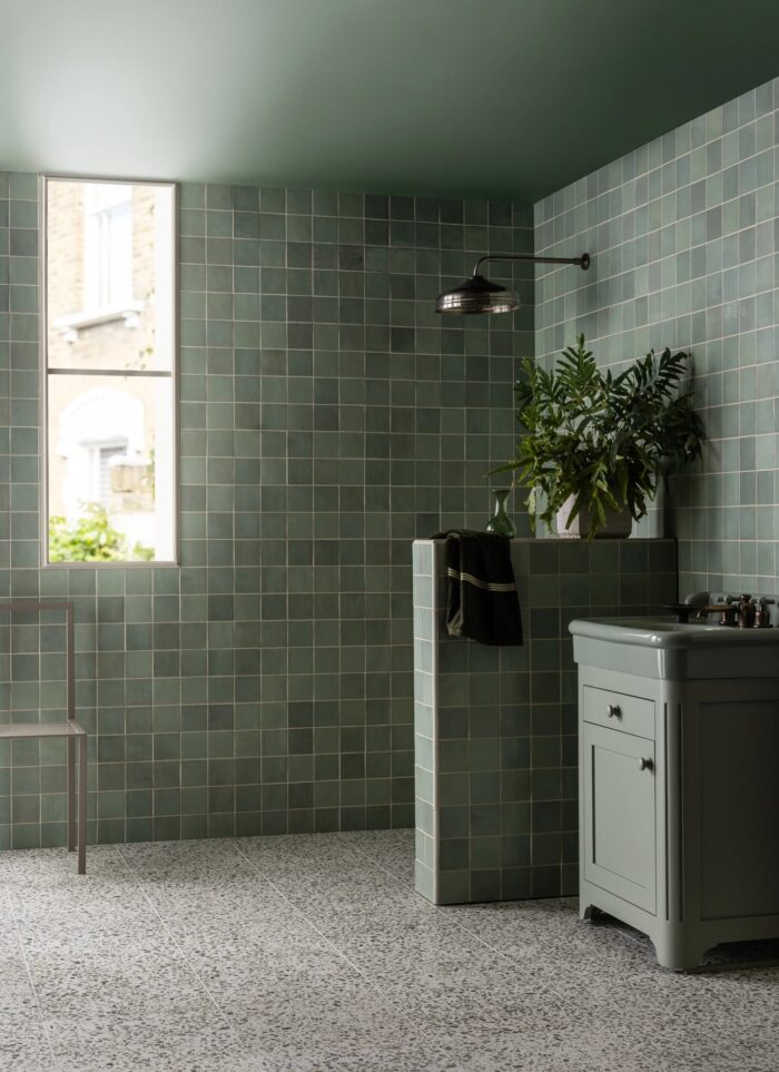 Mint green Zellige style tiles on a bathroom wall and shower.